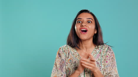 Woman-happily-clapping-hands,-reacting-to-good-news