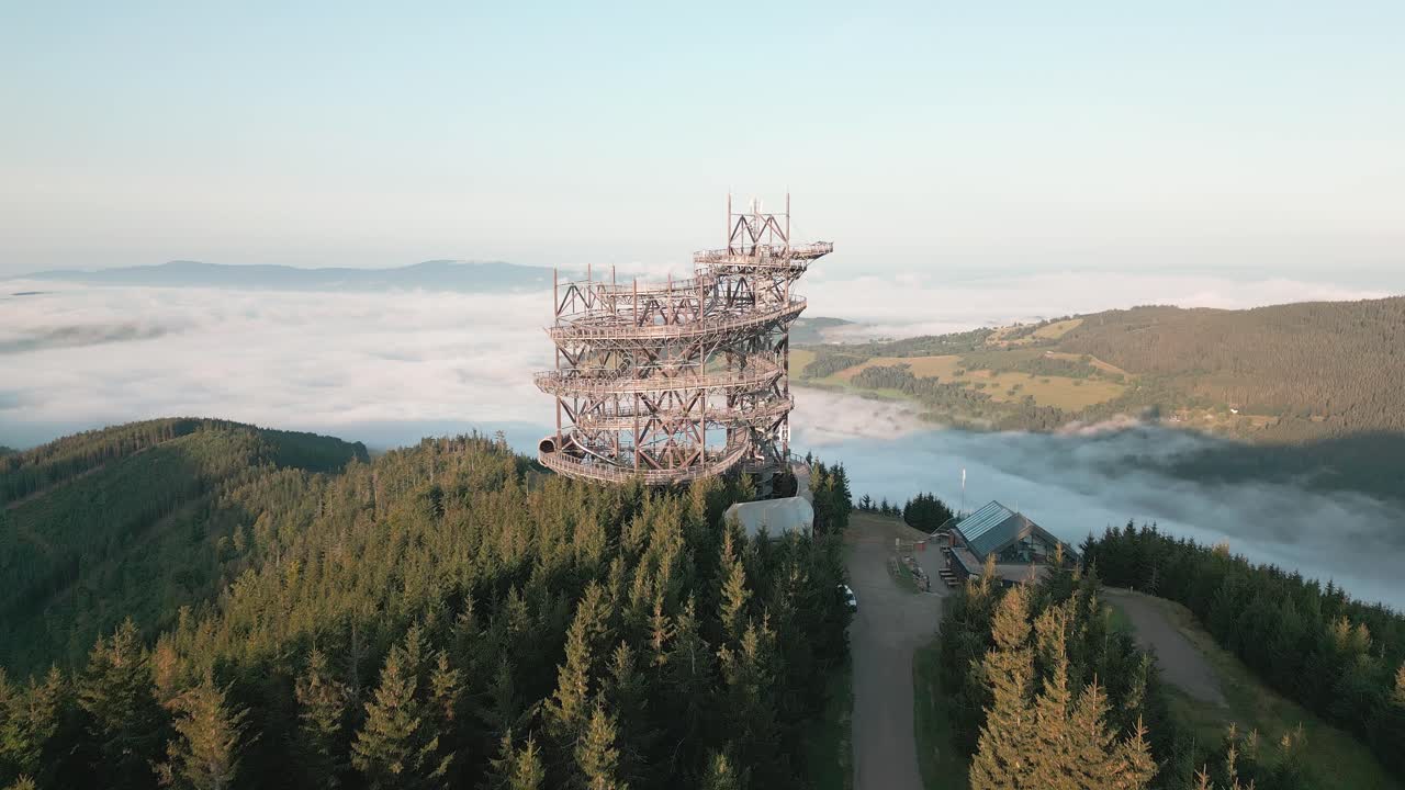 Monumental lookout tower Sky walk towering above the clouds shrouding the mountain valley
