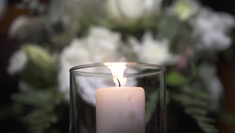 flame of decorative candle in glass container for luxurious table settings