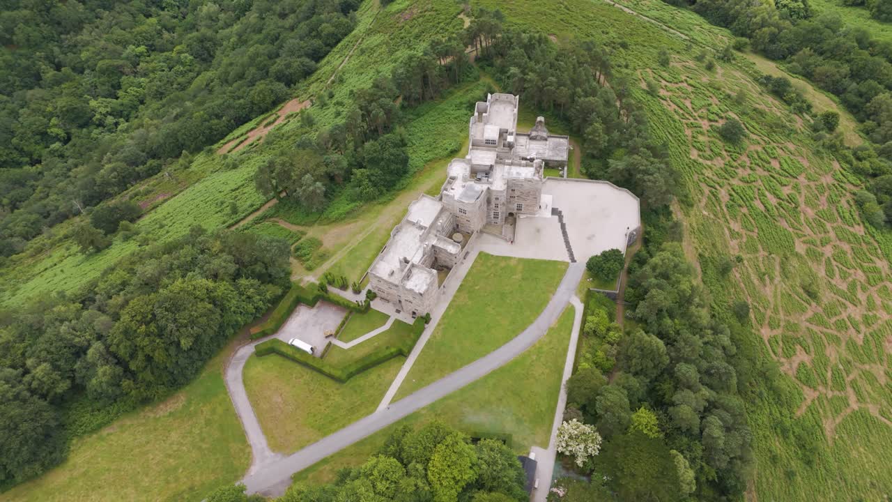 Aerial View of a Grand Castle Estate on a Lush Green Hill