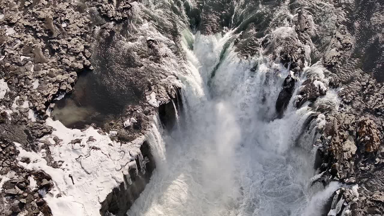 Aerial view of Selfoss waterfall in Iceland, with icy cliffs and powerful cascading water.