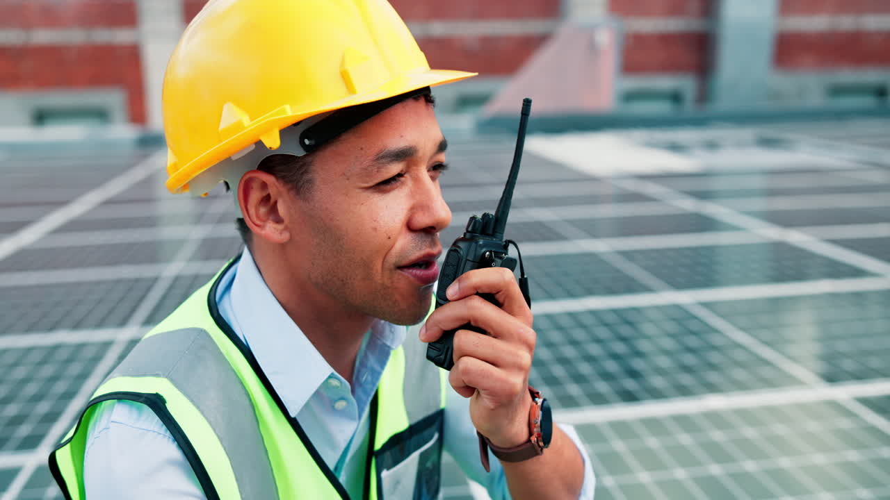 Construction Worker Communicating with Walkie-Talkie on Solar Panel Site