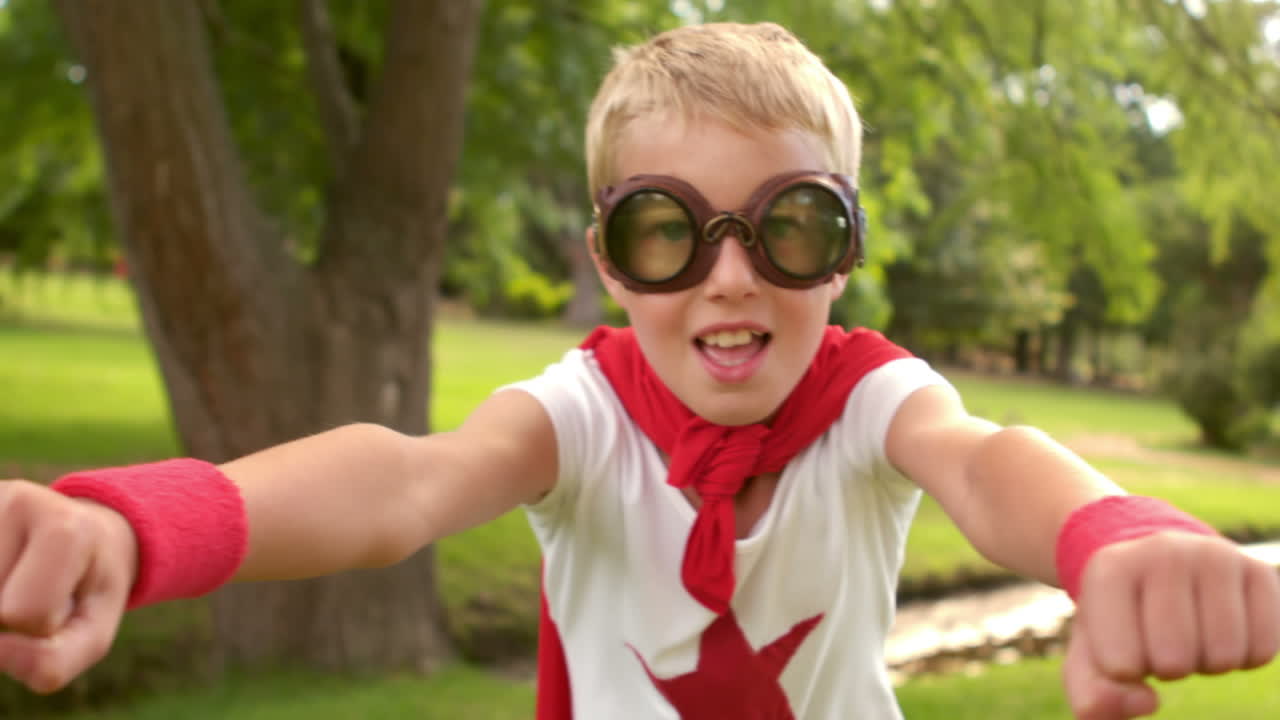 un niño pequeño fingiendo ser un superhéroe.