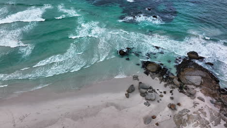 South-Africa-aerial-cinematic-drone-surf-waves-crashing-coastline-Chapman-Peak-Noordhoek-Cape-Town-Hout-Bay-Fish-Hoek-Good-Hope-Simon's-Town-stunning-aqua-deep-blue-water-rugged-rocks-pan-down-motion