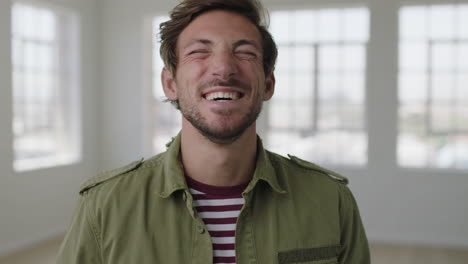 close up portrait of attractive young man laughing cheerful enjoying lifestyle happy caucasian guy in apartment background