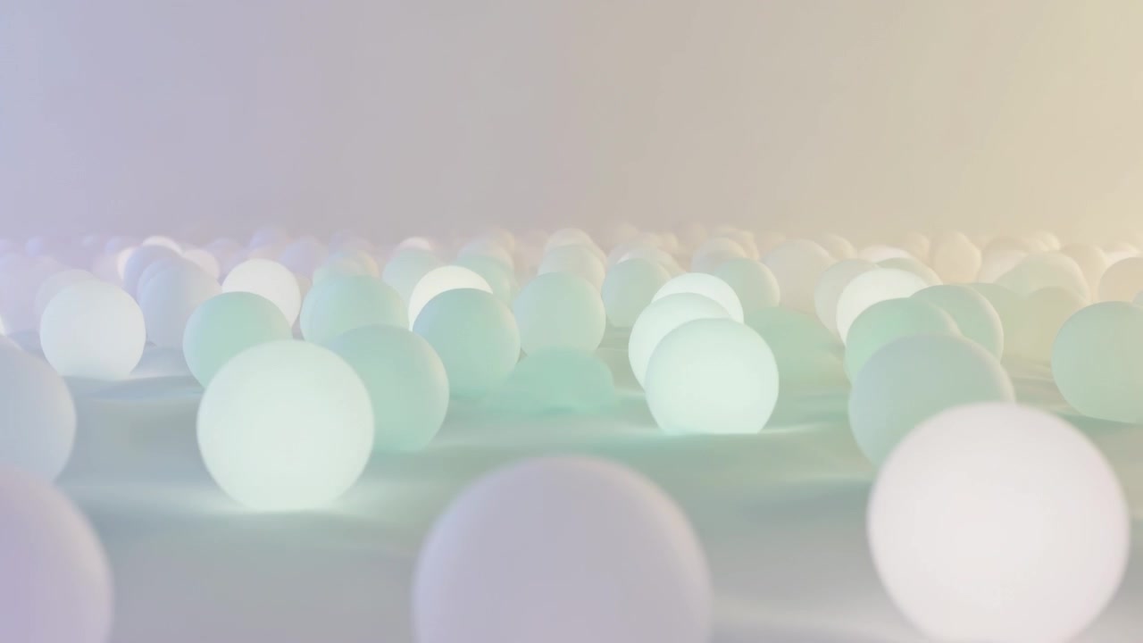 Une caméra en mouvement effectue une mise au point, révélant une sphère au premier plan dans un studio orné de sphères lumineuses.
