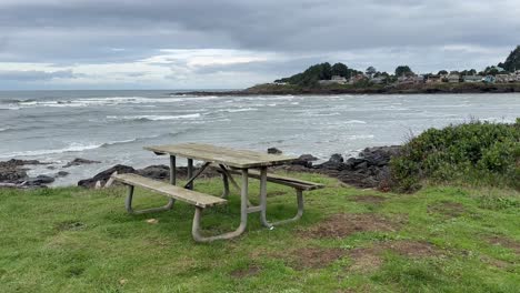 old grunge bench near shoreline with rolling sea waves