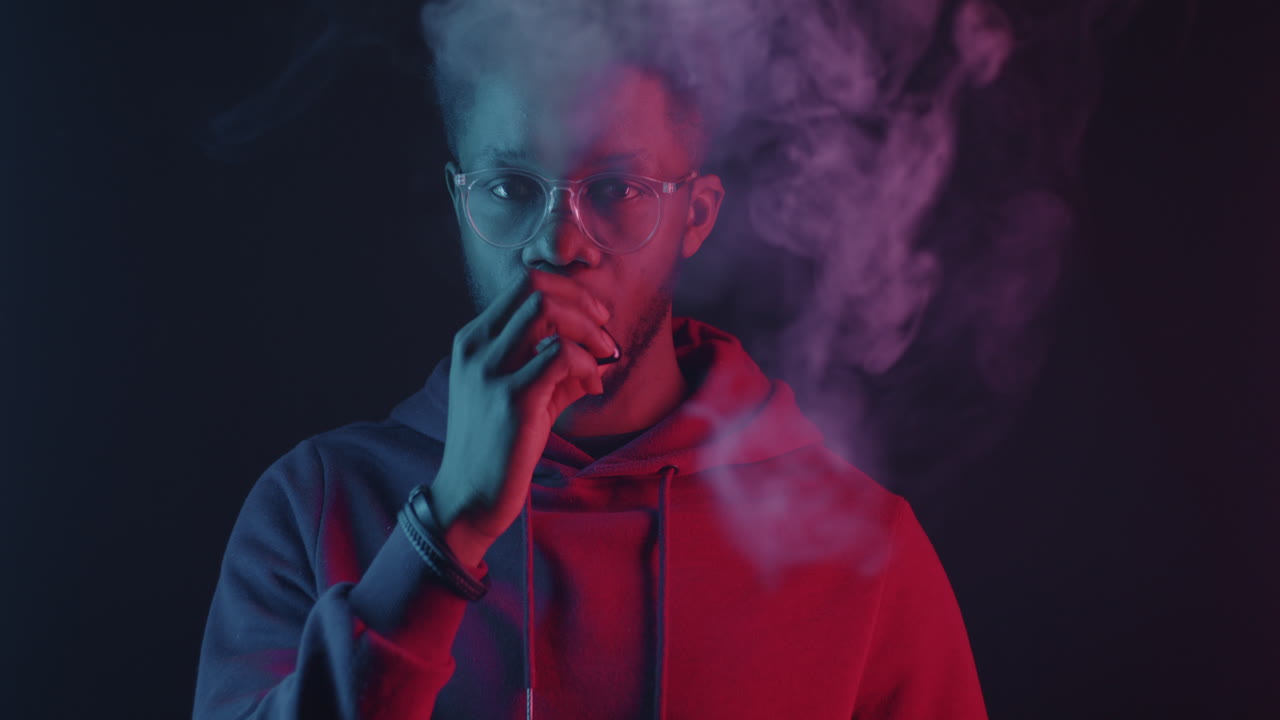 Man vaping in neon light