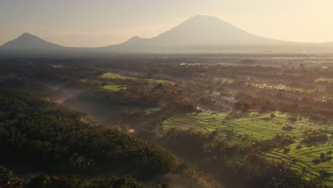 Cinematic-aerial-view-of-gorgeous-holy-volcano-Agung-with-foggy-tropical-rainforest-in-Eastern-Bali,-Indonesia