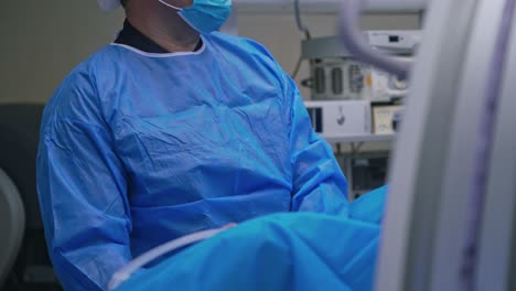 surgeon during the operation. professional doctor in medical uniform performs an operation to a patient together with nurse in the hospital.