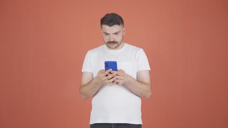 Happy-man-texting-on-the-phone.-Smiling.