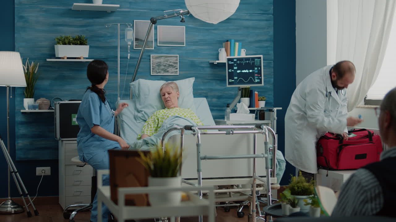 Medical team consulting ill senior woman in hospital bed