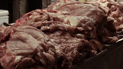 stack-of-fresh-meat-in-butcher-shop-in-market-environment