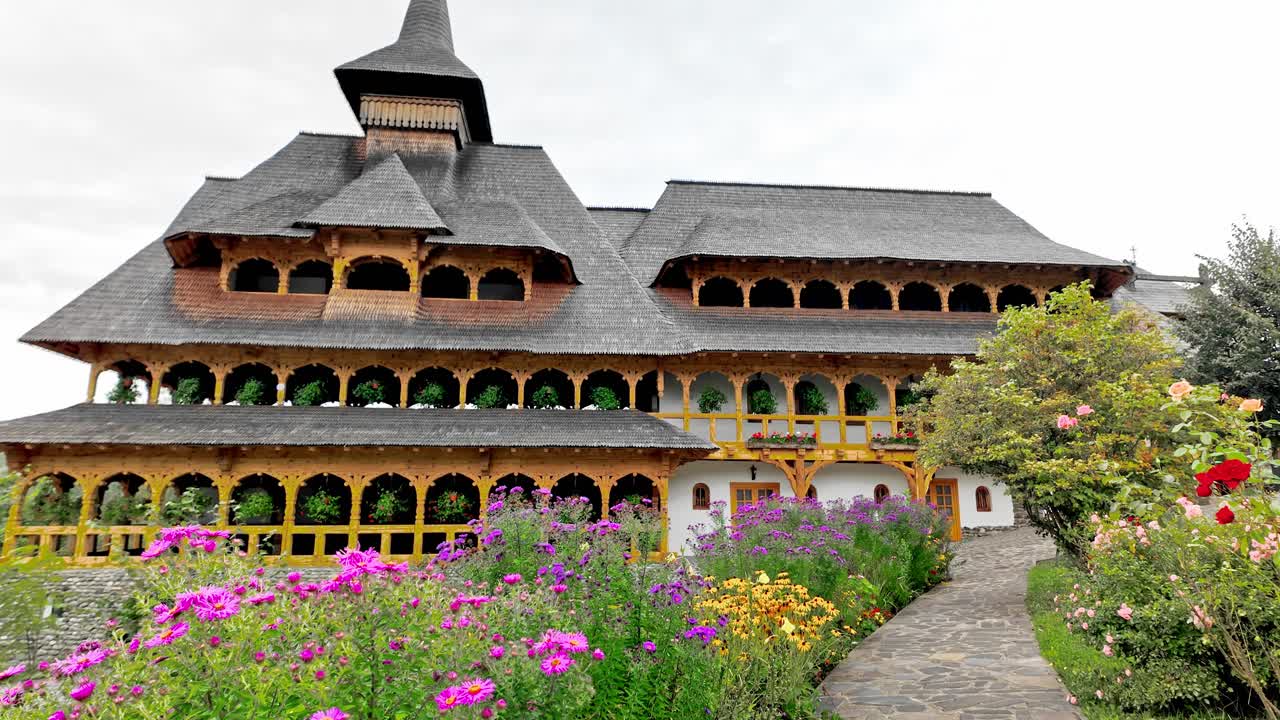 Colourful flower garden at wooden monastery complex Maramures