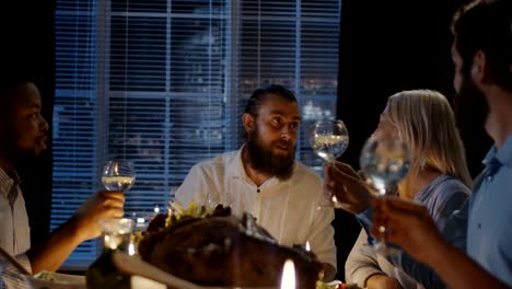 friends toasting at table on thanksgiving day