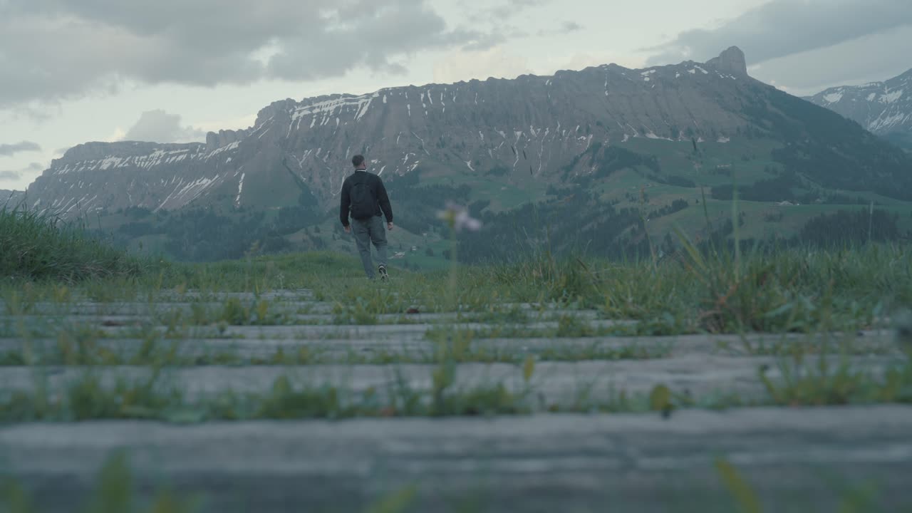 Lonely Walk Through Alpine Landscape. Hiker Walking on Wooden Path in Mountains. Adventure in the Swiss Alps at Twilight 50P.