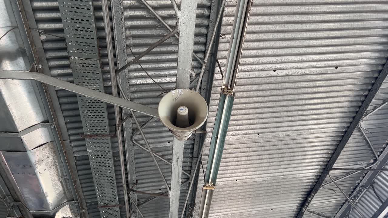 The railway station's microphone and announcements are being made.