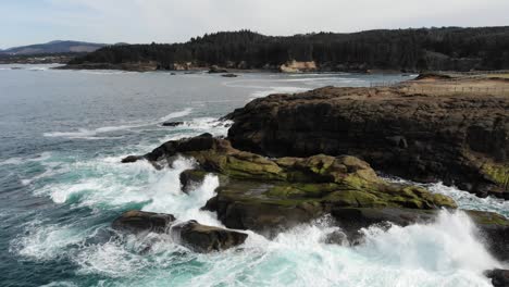 Drone-flies-over-craggy-coastline