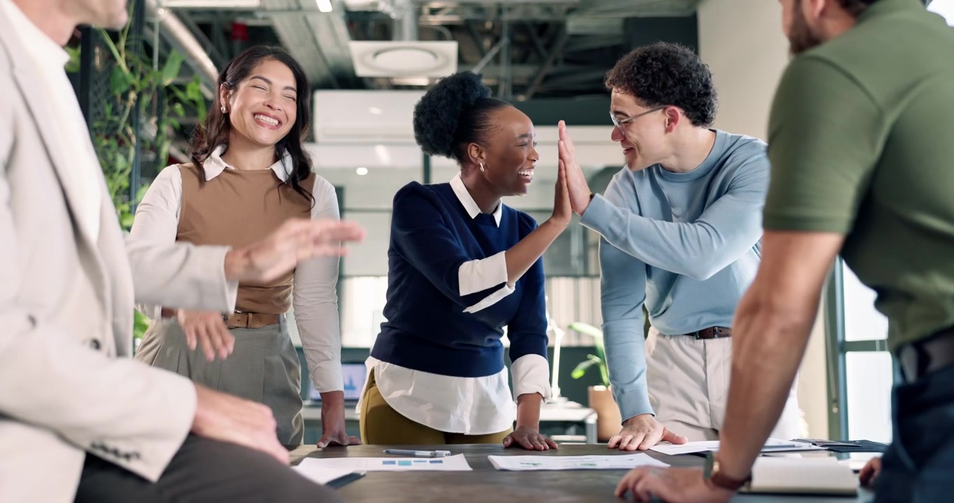 Diverse Business Team Celebrating Success with High Fives in Office