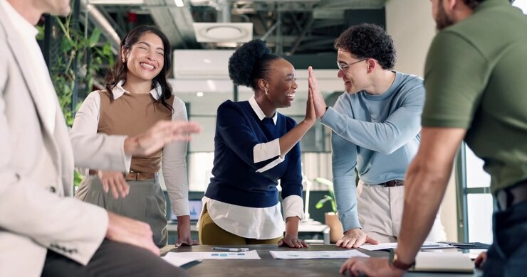 Diverse Business Team Celebrating Success with High Fives in Office