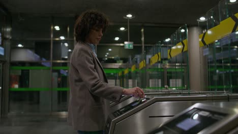 woman using subway turnstiles