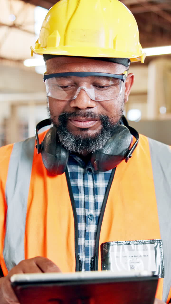 Focused Construction Worker Using a Digital Tablet