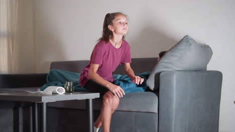 caring sister covers sleeping brother with blanket, walks away, medication on table, thoughtful caregiving, sibling care, concern for health, family support, healing