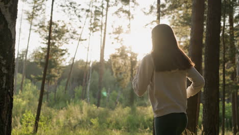 woman running in the forest at sunset