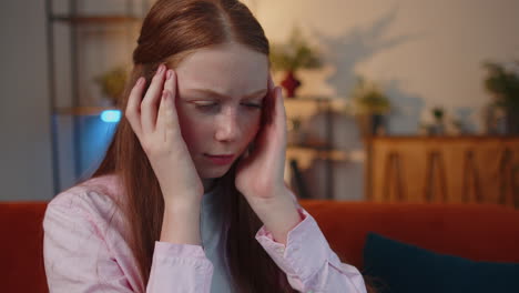 close-up portrait of tired woman teacher suffering from tension, migaine headache at home office