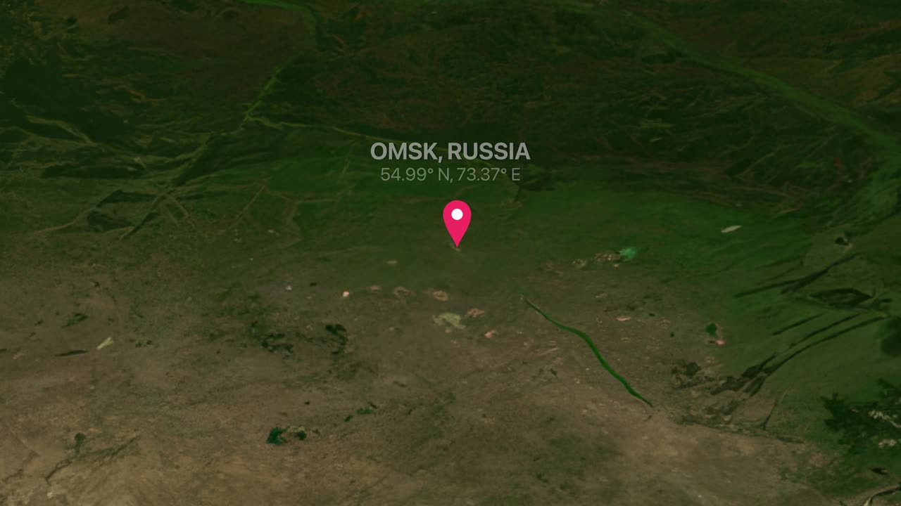 A digital earth render zooms from a flat world map into Omsk, Russia with pin