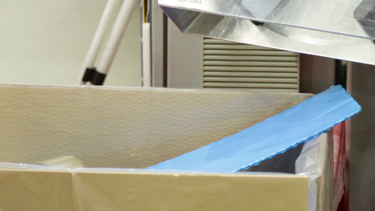 Operational Cap lining Machine Producing Bottle Caps, piling into a box