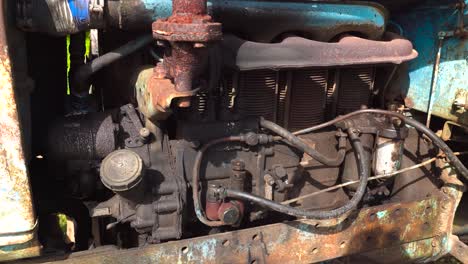 Old-soviet-tractor-engine-working-with-oil-leakage-from-tube,-Latvia