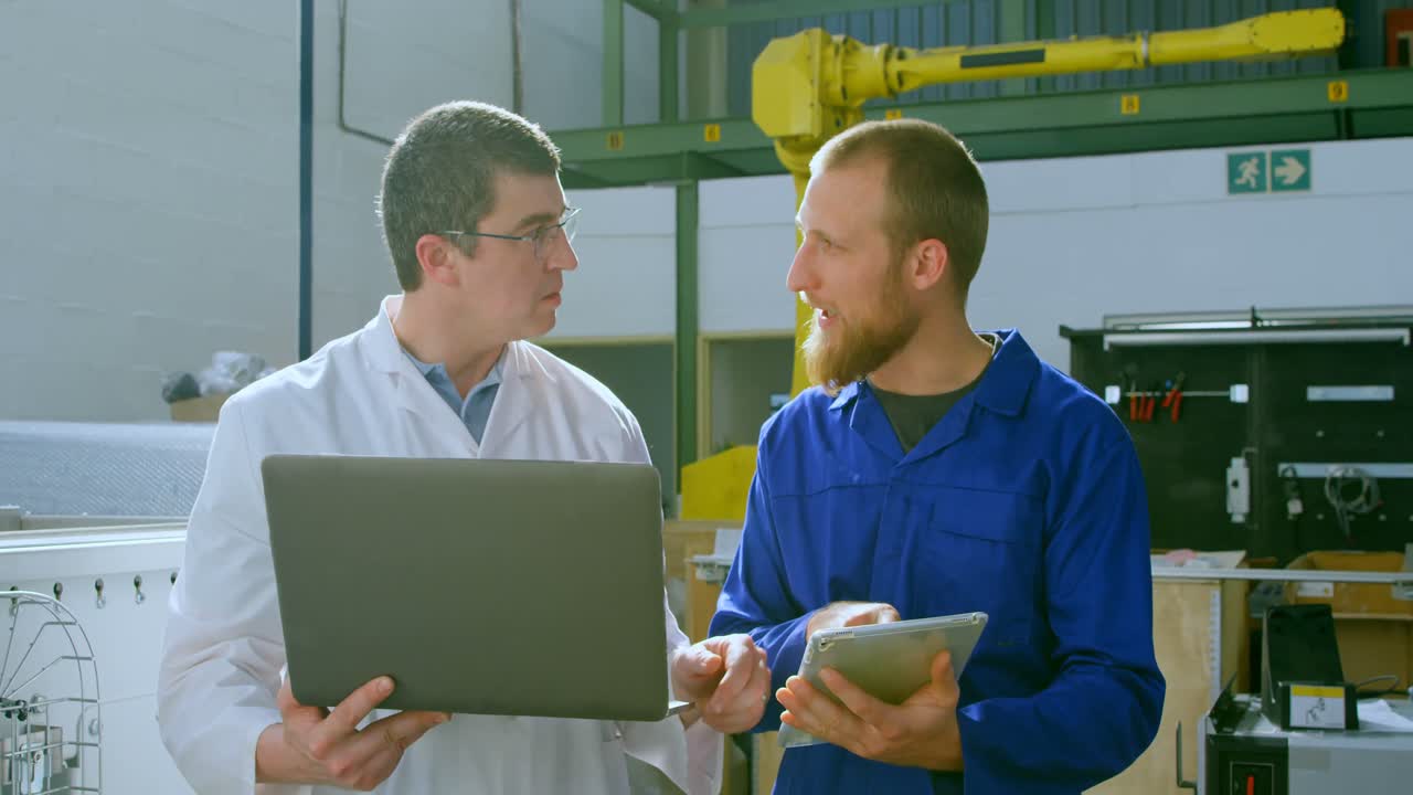 Robotic engineers discussing over digital tablet 4k