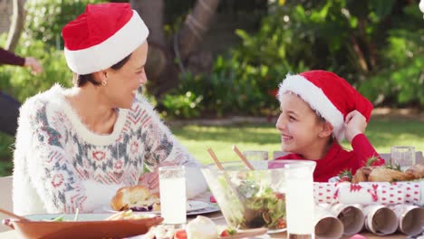 Happy-caucasian-family-having-christmas-dinner-in-garden