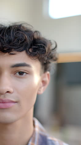 Vertical video: Smiling young person at home, embracing identity with confidence and warmth