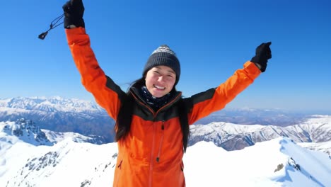 joyful ascendancy: a young adventurer celebrates reaching the mountain summit under clear blue skies, embracing the thrill of nature's majesty