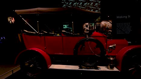 a classic car displayed in a museum setting