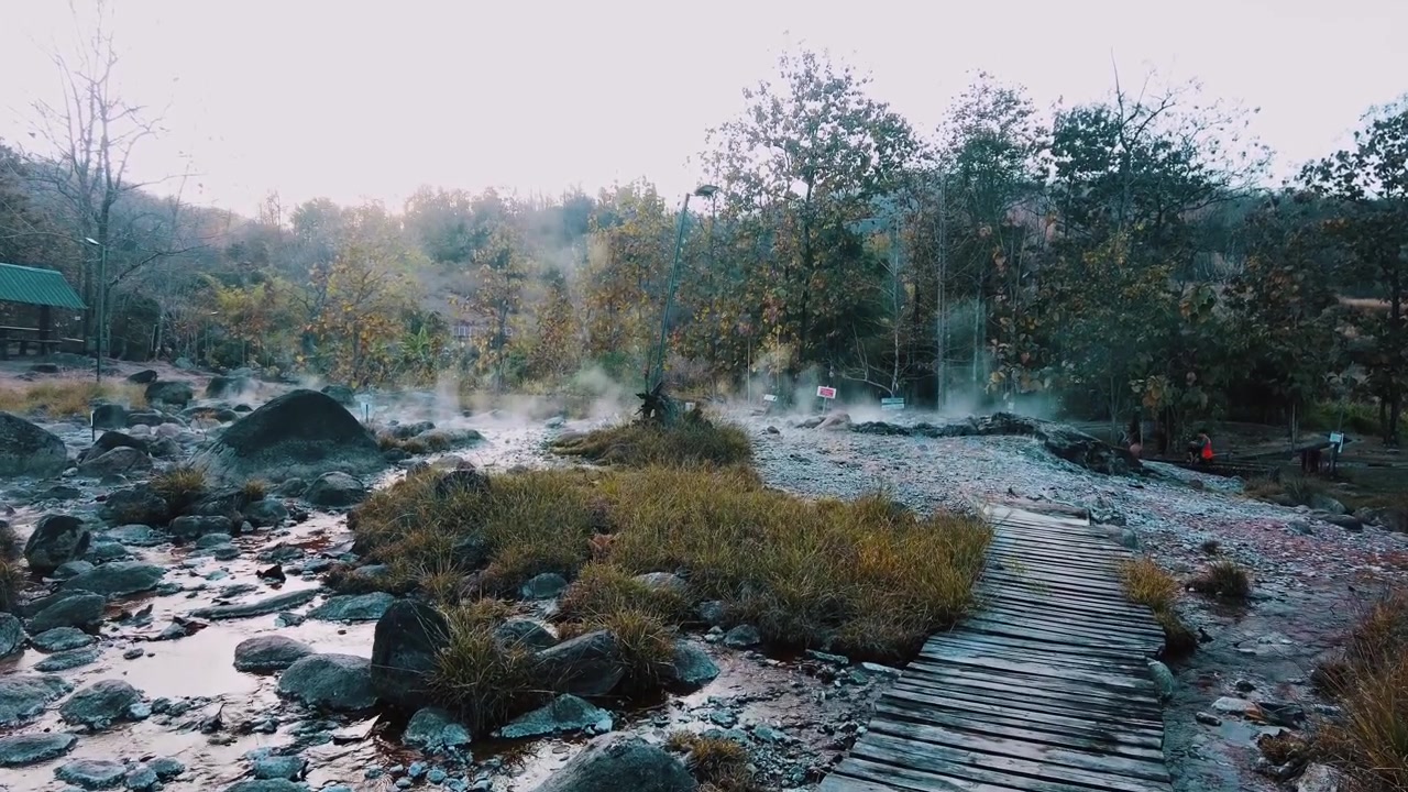 wooden bridge in to muang rae hot spring. boiling river water source in pai thailand