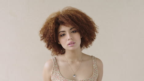 portrait of cute young mixed race girl looking at camera pensive close up of beautiful female afro hair bored waiting