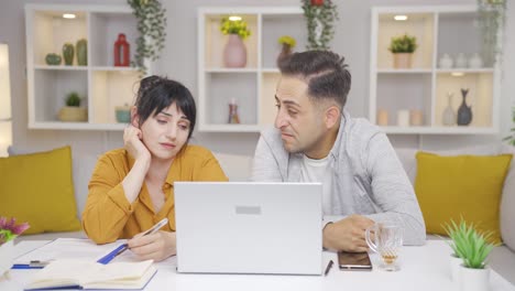 couple tired from doing work on laptop.