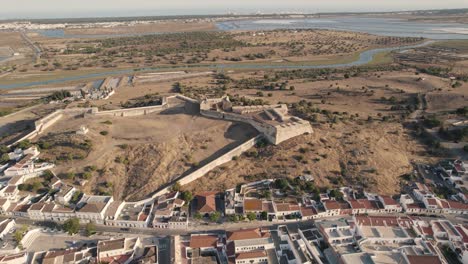 panning aerial landscape of são sebastião de castro marim fortress with vast expense of salt marsh