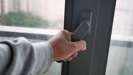 person opening a window or door