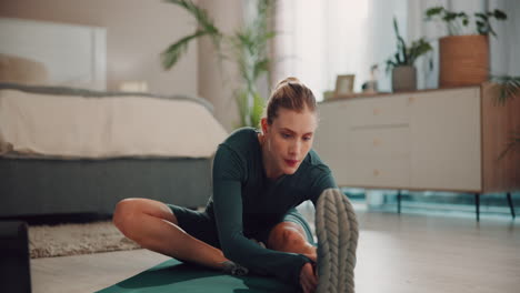 woman doing yoga stretches at home