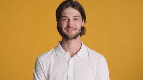 caucasian man making ok gesture on yellow background.