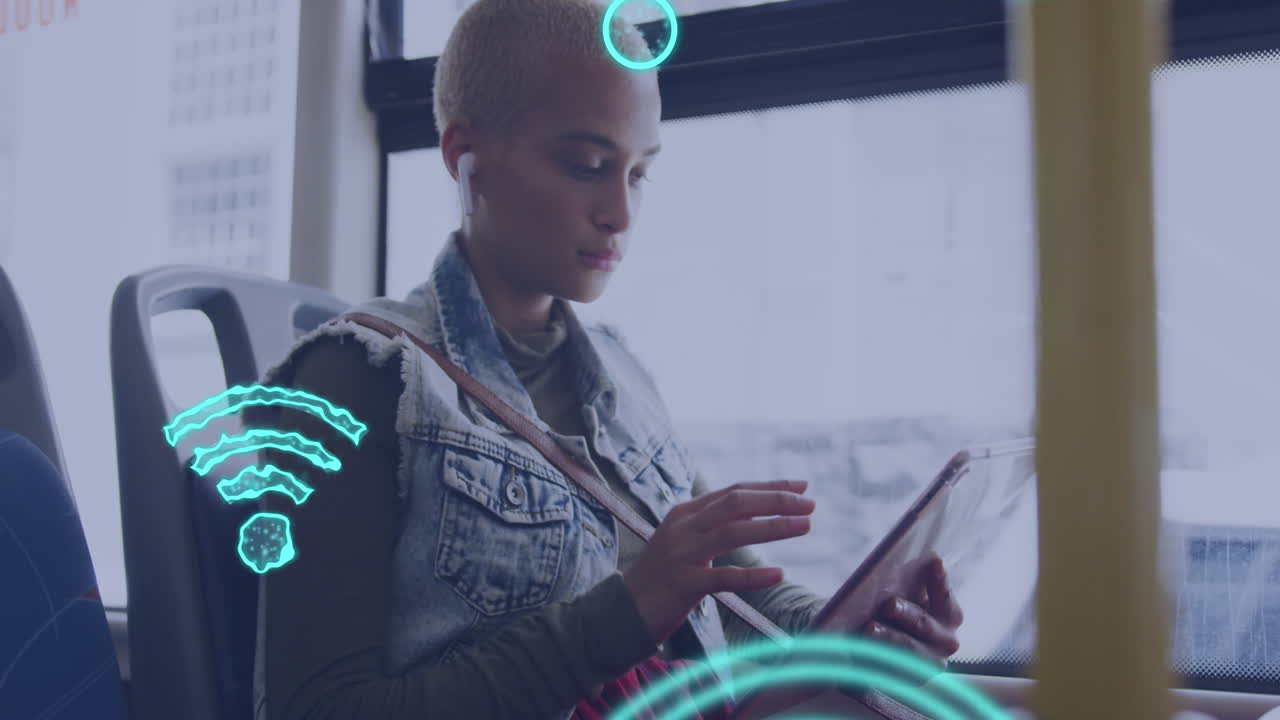 Animation of social media icons over biracial woman in bus using tablet