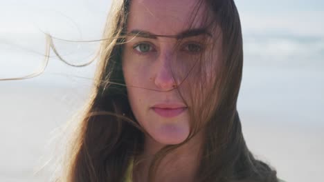 Portrait-of-caucasian-woman-at-the-beach-on-sunny-day