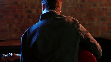 rear view of musician playing guitar