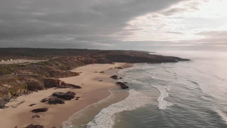 remote golden sand beach on atlantic coastline, portugal