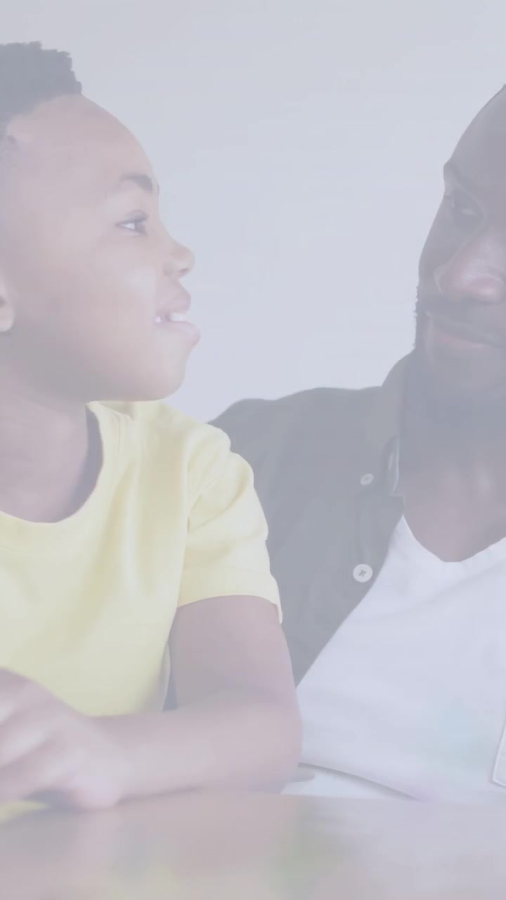 Vertical video: Father listening while child speaking at table, guiding education, strap crossing