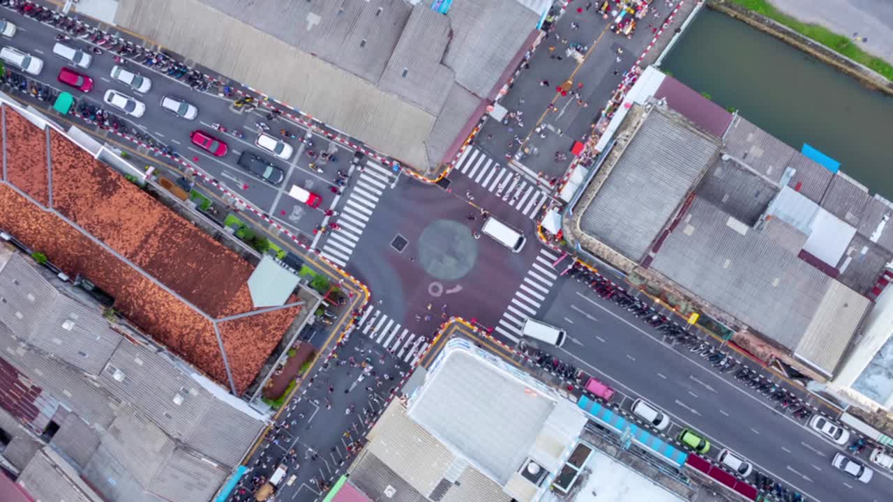 Aerial view Timelapse Beautiful top view Hyperlapse of cars traffic at phuket city downtown street lane and buildings and people crossing road.Transportation and Travel background concept